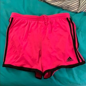 Bright pink pair of women’s adidas training shorts